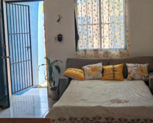 a couch with pillows on it in a living room at Casa Campestre en Pueblo Mágico in Santa Bárbara