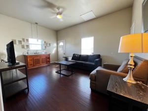 a living room with a couch and a table at Spacious King Suite with Private Bath - Central, 10 Min Downtown Access in San Antonio