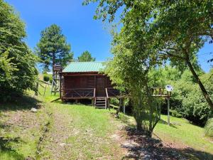 a log cabin in the middle of a field at Rincon Soñado in Villa Yacanto