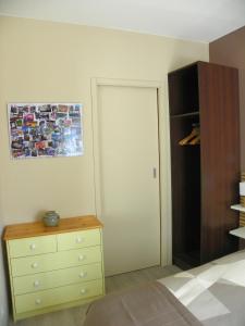 a bedroom with a bed and a dresser and a closet at Provencal Vintage Cocoon in LʼIsle-sur-la-Sorgue