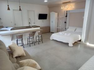 a living room with two beds and a kitchen at Suíte da piscina in Frederico Westphalen