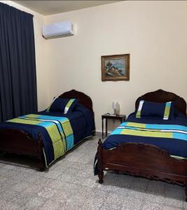 - une chambre avec 2 lits et une table avec une photo dans l'établissement Departamento vintage, à Papantla 1 autre photo