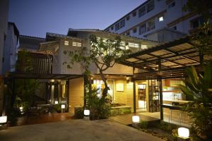 an external view of a house at night with lights at Uncle Loy's Boutique House in Bangkok
