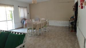 a dining room with a table and chairs in a room at Sol y Luna in Termas de Río Hondo