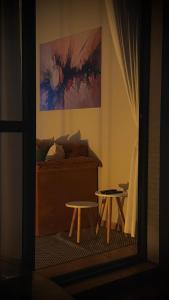 a bedroom with a bed and a table and a painting at Pitangueiras Pé na Areia in Guarujá +23 photos