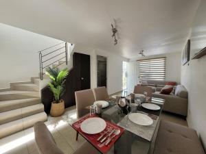 a living room with a dining table and a couch at Casa Privada El Marqués Qro in Querétaro