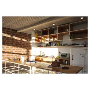 a kitchen with a counter and a brick wall at Casa PDS in La Porteña +5 photos