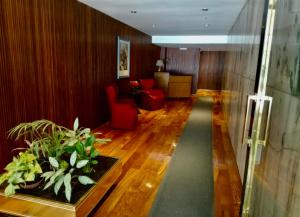 a living room with a red chair and a couch at Apart juncal in Buenos Aires