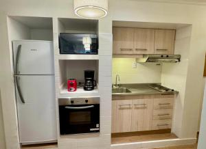 a small kitchen with a refrigerator and a sink at Apart juncal in Buenos Aires