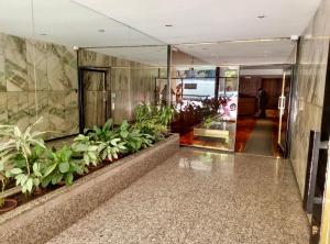 a lobby of a building with plants on the walls at Apart juncal in Buenos Aires +2 photos