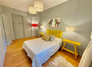 a small bedroom with a bed and a table at Apart juncal in Buenos Aires