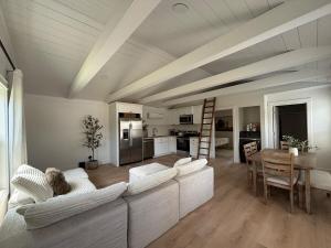 a living room with couches and a table and a kitchen at Luxury BoilingSprings Getaway in Boiling Springs