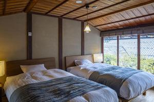 En eller flere senge i et værelse på NIPPONIA 福住 宿場町