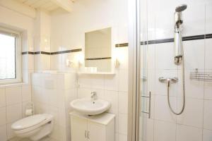 a bathroom with a toilet and a sink and a shower at Haushaelfte-Hein-105 in Böhl
