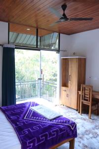 a bedroom with a bed and a ceiling fan at Half moon holiday home - 4 Bedroom Villa in Anachal