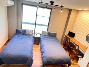 Letto o letti in una camera di 映画館みたいなお部屋で非日常体験 キッチン付きで家族も安心 1日1組限定貸切ステイ シンカイハウス