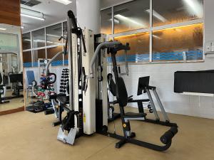 a gym with several tread machines in a room at Flat particular no hotel Fusion in Brasilia