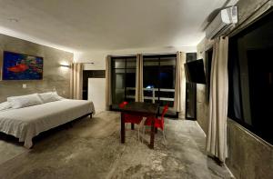 a bedroom with a bed and a table and a television at Very quiet in Isla Mujeres