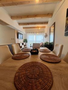 グアテマラシティにあるLindo apartamento cerca del aeropuertoの大きな木製のテーブルと椅子、リビングルームのある部屋