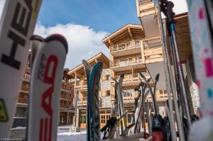 a row of skis parked in front of a building at CGH Résidences & Spas Kalinda in Tignes