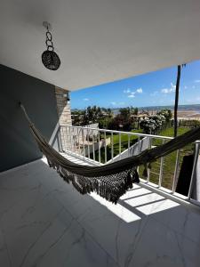 a hammock in a room with a balcony with a view at Home Beach Peroba, Maragogi,alagoas in Maragogi +102 photos