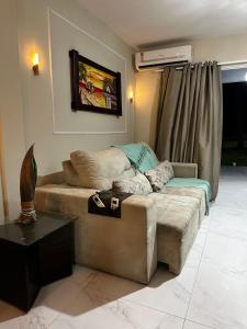 a living room with a couch and a table at Home Beach Peroba, Maragogi,alagoas in Maragogi