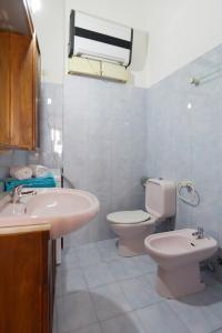 a white bathroom with a sink and a toilet at San Severo in Venice