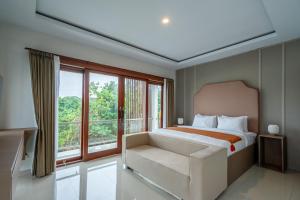 a bedroom with a bed and a large window at Villa Latsu Canggu in Canggu +21 photos