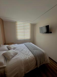 Postel nebo postele na pokoji v ubytování Increíble Apartamento Para Tu Estadía En Tunja