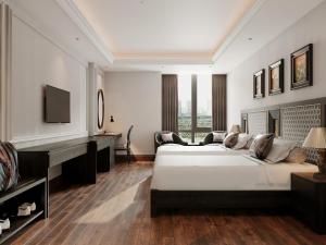 a bedroom with a bed and a desk and a piano at MT Collection Hotel Ha Long in Ha Long +5 photos