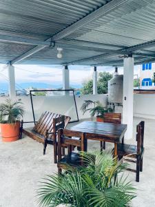 a picnic table and benches under a pavilion at Casa con vista al lago y parqueo en la zona viva in San Pedro La Laguna