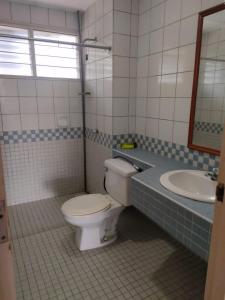 a bathroom with a toilet and a sink at Seri Bulan Coastal Homestay in Kampung Teluk Kemang