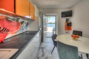 a kitchen with a table and a view of the ocean at Sunny Apartment Octopus in Prožura