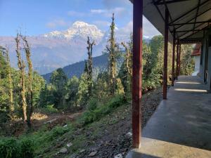 a porch of a house with a view of a mountain at Hotel mardi station and restaurent in Astam