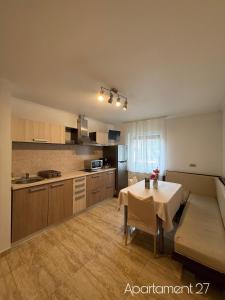 a kitchen with a table and a table and a room at Apartamente Baile Felix in Baile Felix