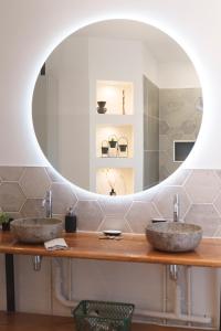 a bathroom with two sinks and a mirror at " La belle vie ", Demeure de charme en Champagne in Dormans +25 photos