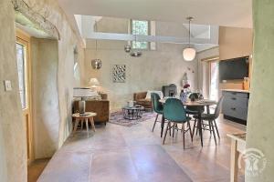 a kitchen and dining room with a table and chairs at De rulinen - cote verger in Saint-Clet