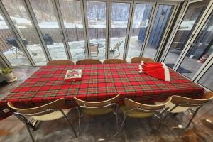 a table with a red plaid table cloth and chairs at Paju Espacio Cantabile in Paju
