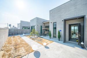 a house with a courtyard in front of it at Peer Haus Private House in Gangneung