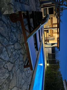 a house with a staircase leading to a pool at night at Ferienhaus In Posedarje Mit Großem Garten in Posedarje