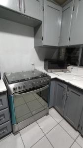 a kitchen with a stove top oven in a kitchen at CENTRAL APARTMENT, casa cuc in Panajachel +22 photos
