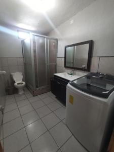 a bathroom with a toilet and a sink and a mirror at CENTRAL APARTMENT, casa cuc in Panajachel