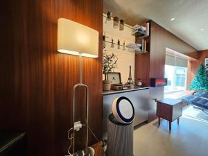 a living room with a table and a lamp in it at Private House Guten Morgen Haeundae Main Branch in Busan +11 photos