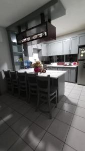 a kitchen with a table and some chairs in it at CENTRAL APARTMENT, casa cuc in Panajachel