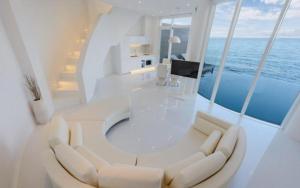 a white room with a table and chairs on a yacht at Pohang Escape Ocean View Pool Villa in Hajŏng-ni