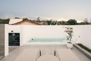 a balcony with two benches and a view of the ocean at Romantic Rooftop Jacuzzi Villa with Sunset Views in Jelutong