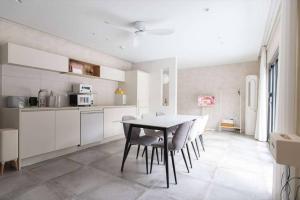 a kitchen and dining room with a table and chairs at Stay Yeon in Miryang