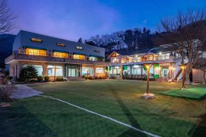 a large house with a large yard at night at Gapyeong The Srping Pension in Gapyeong