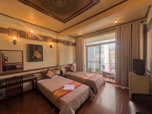Postel nebo postele na pokoji v ubytování BI SAIGON Hotel - BUI VIEN WALKING STREET