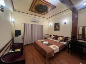 Postel nebo postele na pokoji v ubytování BI SAIGON Hotel - BUI VIEN WALKING STREET